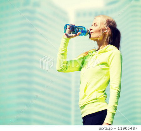 woman drinking water after doing sports outdoors woman drinking water after doing sports outdoors 11905487