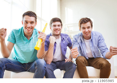 happy male friends with vuvuzela happy male friends with vuvuzela 11905985