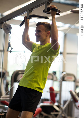 smiling man exercising in gym smiling man exercising in gym 11906588