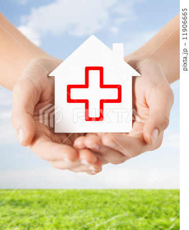 hands holding paper house with red cross hands holding paper house with red cross 11906665