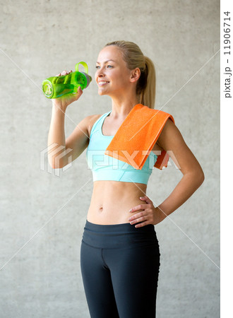 woman with bottle of water in gym woman with bottle of water in gym 11906714