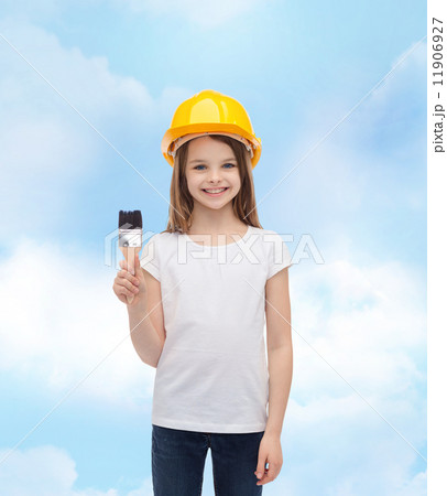 smiling little girl in helmet with paint roller smiling little girl in helmet with paint roller 11906927