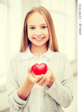 beautiful teenage girl showing red heart 11907353