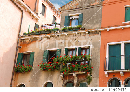 Picturesque Italian house with flowers on the balconies 11909452