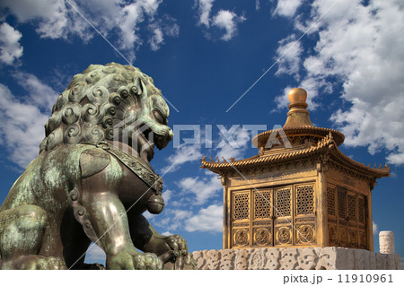 Bronze Guardian Lion Statue and bronze pagoda in the Forbidden City, Beijing, China 11910961