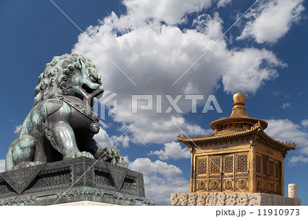 Bronze Guardian Lion Statue and bronze pagoda in the Forbidden City, Beijing, China Bronze Guardian Lion Statue and bronze pagoda in the Forbidden City, Beijing, China 11910973