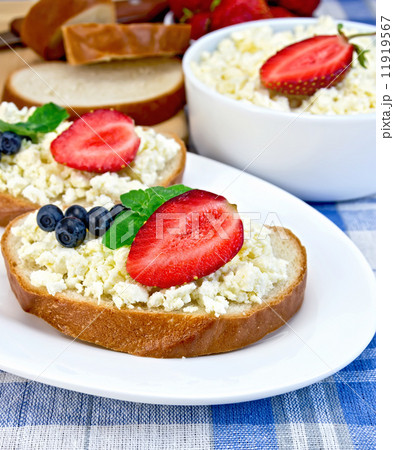 Bread with curd and berries on blue cloth 11919567