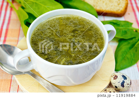 Soup of greens on the fabric with a spoon 11919884
