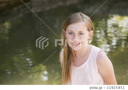 A young girl by a stream. A young girl by a stream. 11925851