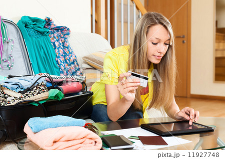 woman using credit card and tablet 11927748