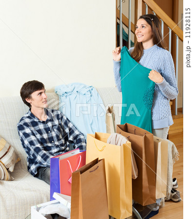Happy guy and girl with purchases 11928115