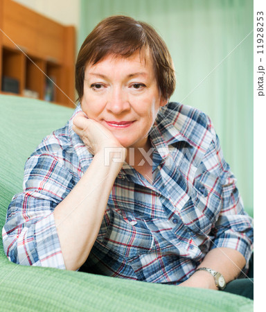 Stressed female pensioner on couch 11928253