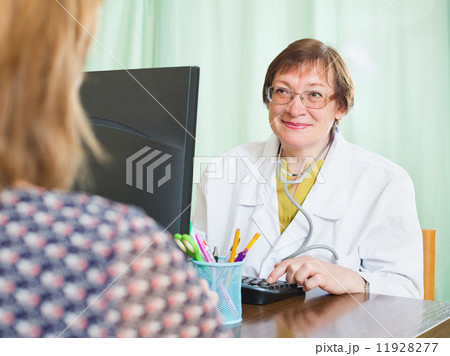 Doctor inserting information about patient 11928277