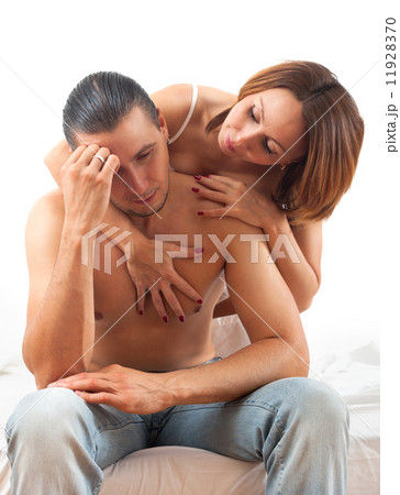 Woman consoling the depressed husband in bed Woman consoling the depressed husband in bed 11928370