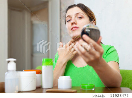 woman looks on her neck 11928475