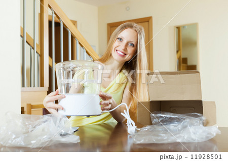 young housewife with steamer in home 11928501