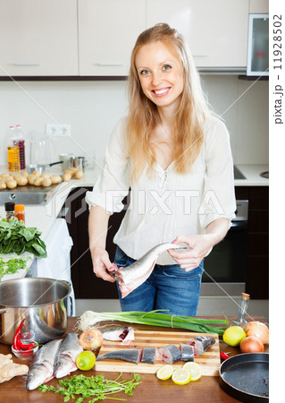 Happy woman cooking saltwater fish Happy woman cooking saltwater fish 11928502