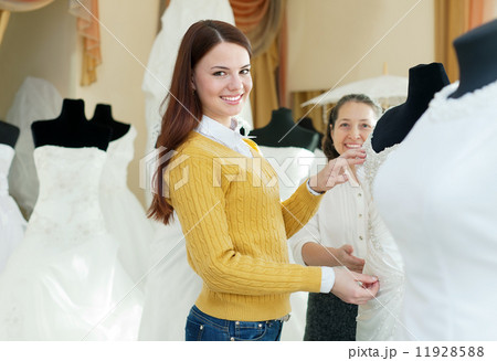 happy women chooses bridal outfit 11928588