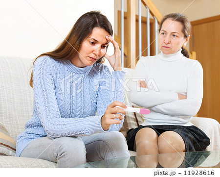 Sad woman looking at pregnancy test Sad woman looking at pregnancy test 11928616