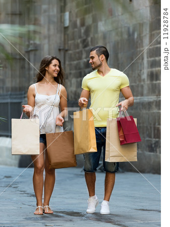 smiling loving couple with shopping bags at city smiling loving couple with shopping bags at city 11928784