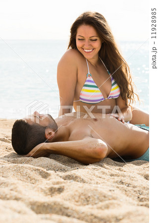 Loving pair laying on sand beach 11928985