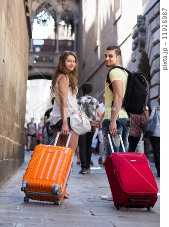Travelers with baggage in the street 11928987