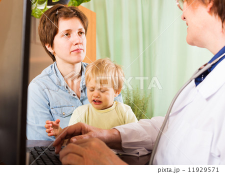 woman with baby listening doctor at clinic woman with baby listening doctor at clinic 11929571