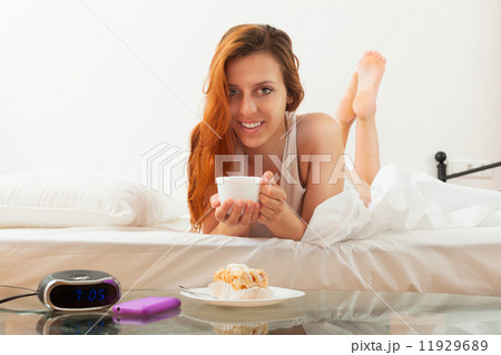 Young long-haired woman having breakfast Young long-haired woman having breakfast 11929689