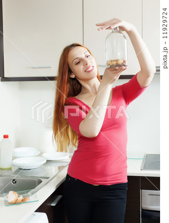 woman in red cleaning glass bottle with egg shell 11929724