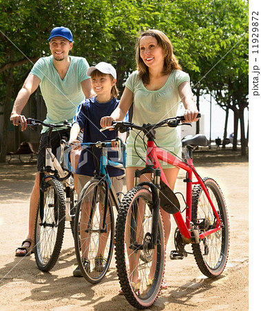 family spending free time in the park family spending free time in the park 11929872