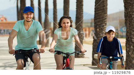 Happy parents with son riding bicycles Happy parents with son riding bicycles 11929876