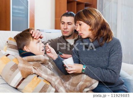 Parents giving pills to boy Parents giving pills to boy 11929885
