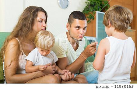 Parents scolding child in home 11930162