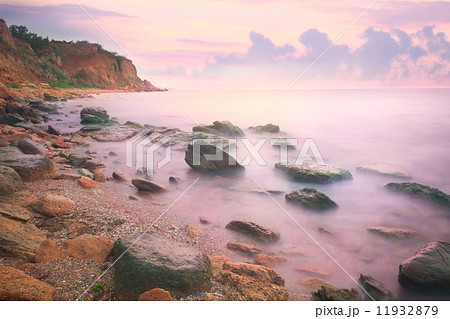Colorful Sunset over the Sea and Rocky Coast 11932879