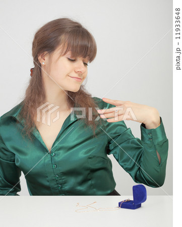 Young woman admires new jewel 11933648