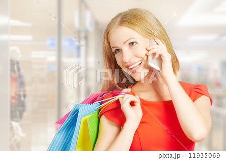 happy woman with  bags on shopping, talking on phone 11935069