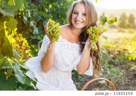 Portrait of young beautiful woman holding grapes 11935259