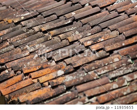 Old red weathered clay tiled roof surface Old red weathered clay tiled roof surface 11935655