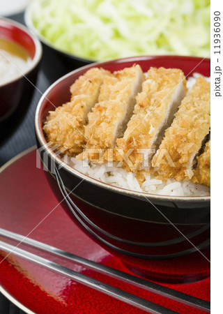 Tonkatsu - Japanese breaded, deep-fried pork cutlet on top of boiled rice. 11936090