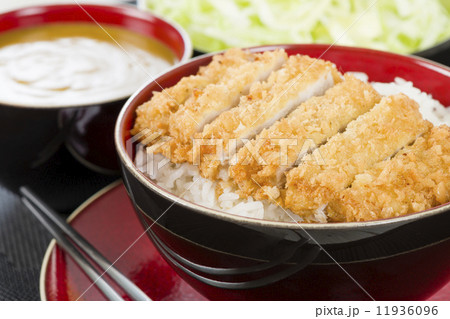 Tonkatsu - Japanese breaded, deep-fried pork cutlet on top of boiled rice. 11936096