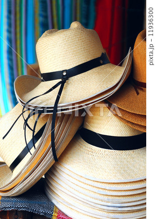 Handmade traditional Panama Hats are stacked for sale at the out Handmade traditional Panama Hats are stacked for sale at the out 11936300