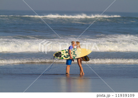 Surfers on Beach Having Fun in Summer. 11939109