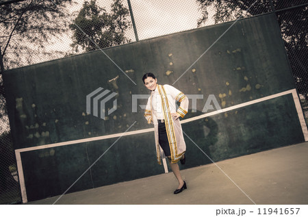 The female graduation portrait in academic gown is looking forwa 11941657