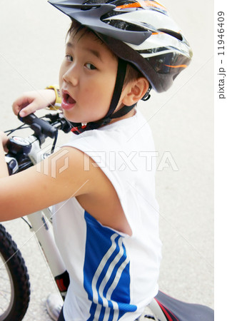 Cycling boy looking back Cycling boy looking back 11946409