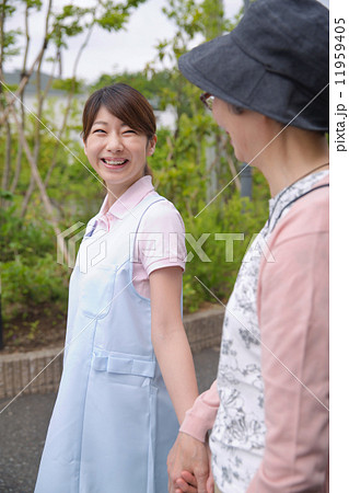 手を繋ぐ介護福祉士とシニア女性 手を繋ぐ介護福祉士とシニア女性 11959405