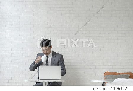 Asian business man in lobby, coffee break Asian business man in lobby, coffee break 11961422