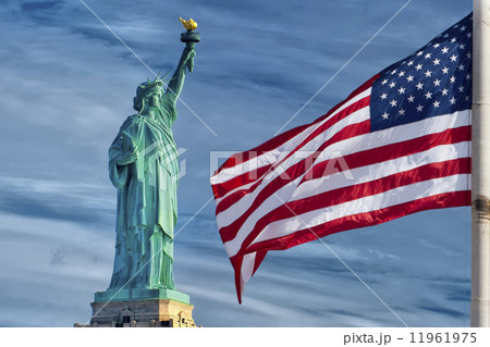 Usa American flag stars and stripes on statue of liberty blue sky background Usa American flag stars and stripes on statue of liberty blue sky background 11961975