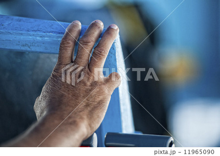 Hand of old man on a fishing boat 11965090