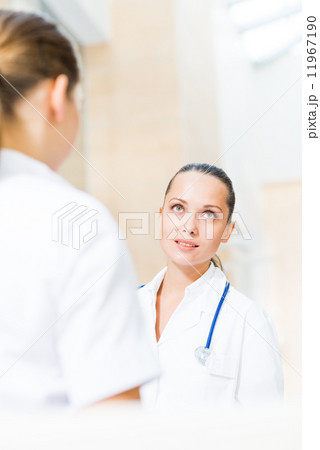 two doctors talking in the lobby 11967190