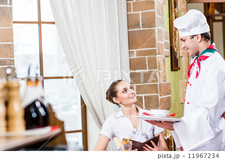 Chef brings a dish pretty woman in a restaurant Chef brings a dish pretty woman in a restaurant 11967234